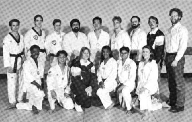 1994 U-M TDK Club portrait. Front row: Natalie Bennett, Daniel Moon, Laura Kistler, Jerilyn Bell, Rakesh Patel, Gudrun Scholler. Standing: Gary J. Gross, Steve L. Busch, Mark A. Rampy, al Salzar, Han S. Lee, Doug Winstanley, Roland Spickermann, Michael Spigarelli, Joseph Lloyd.